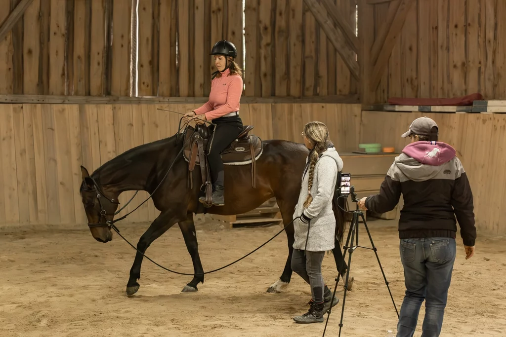 Pferdetrainerin erteilt einer Reitschülerin Unterricht auf ihrem Pferd für einen besseren Sitz